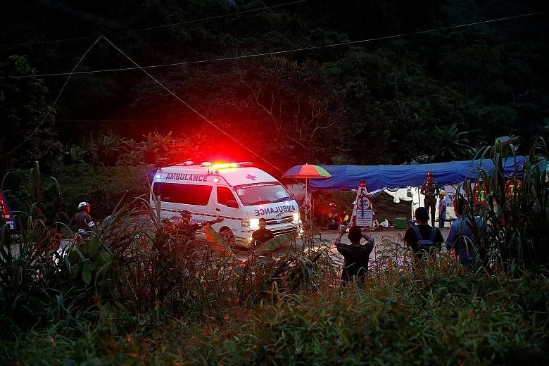 An ambulance leaving the Tham Luang cave area in Chiang Rai yesterday. Each boy brought out of the cave yesterday was examined by doctors before being taken away swiftly to waiting military helicopters. They were flown to Chiang Rai Prachanukroh Hosp