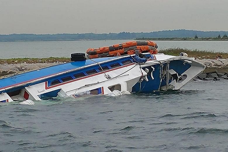 The Indonesian-flagged ferry Sri Kandi 99 ran aground on rocks at the southern tip of Pulau Tekong on Monday night. Singapore Police Coast Guard officers used night-vision technology and searchlights and found five people stuck in the ferry, which wa