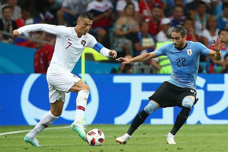 Uruguay's Martin Caceres (right) shows that he is unfazed by the challenge of going against one of the best players in the world in Portugal's Cristiano Ronaldo during their last-16 clash.