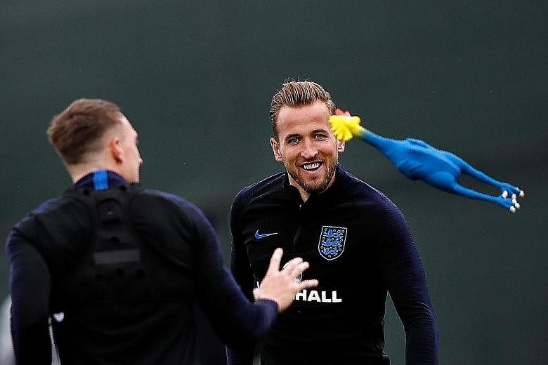 England captain Harry Kane (right) and Phil Jones having a bit of fun with a toy rooster during training as they prepare to take on Croatia in the World Cup semi-finals. Confidence is high in the England camp and they believe they will not chicken ou