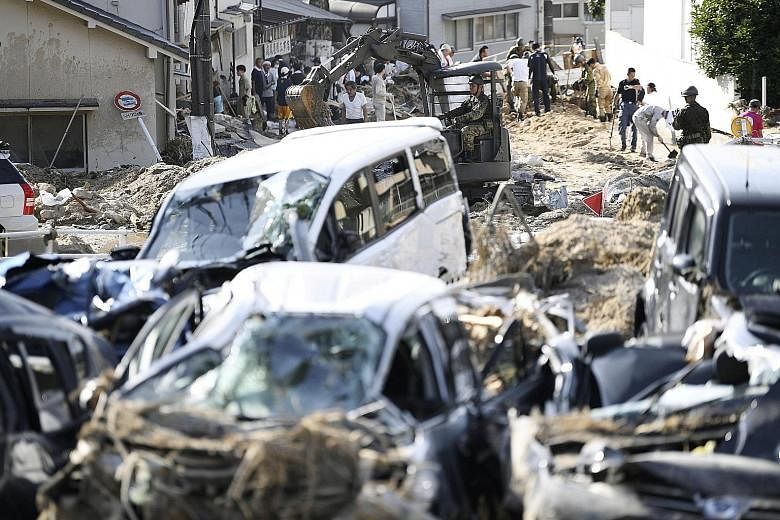 Debris caused by torrential rain being cleared in Aki ward in Hiroshima city in a photo taken by Kyodo yesterday. Hiroshima prefecture was the hardest hit in terms of the number of deaths - 59 - followed by Okayama with 54. The rain has stopped in th