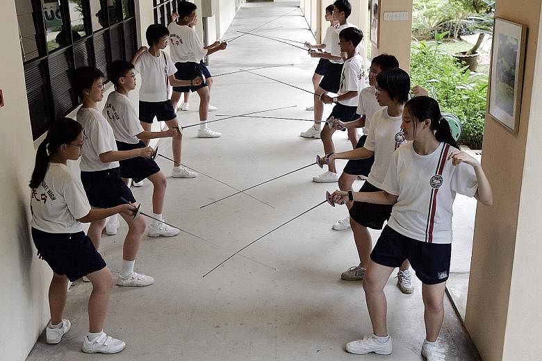 Bukit Panjang Government High students practising their fencing, one of a wide variety of activities which Education Minister Ong Ye Kung said were once seen as being available only to wealthier students, but which are now offered as CCAs.