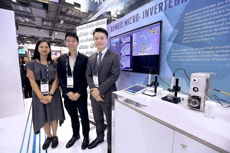 (Above, from right) Microbiologist Martin Tay who, with the assistance of senior biologist Hou Zhisheng and biologist Erica de Souza, developed software for the PUB to automatically detect insect eggs and larvae, at the agency's pavilion at Marina Ba