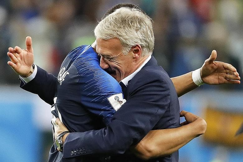An emotional France head coach Didier Deschamps celebrating with teenage star Kylian Mbappe, after the team beat Belgium 1-0 in their World Cup semi-final in St Petersburg to enter Sunday's final in Moscow.