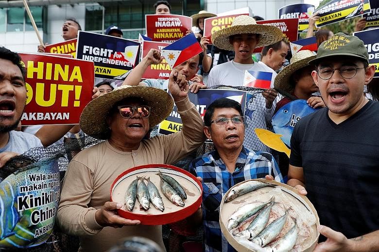 Activists at a rally in Manila last month to protest against the reported harassment of Philippine fishermen at Scarborough Shoal in the South China Sea. Although President Rodrigo Duterte has sung to the tune of pragmatism vis-a-vis the South China 