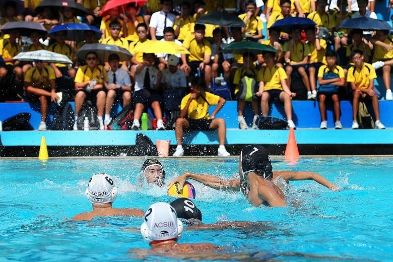 Caylen Wang (7, black) of Raffles Institution (RI) attacking with the ball in yesterday's National School Games water polo boys' C Division final against Anglo-Chinese School (Independent) at the MOE (Evans) Swimming Complex. ACS(I) beat RI 6-3. The 