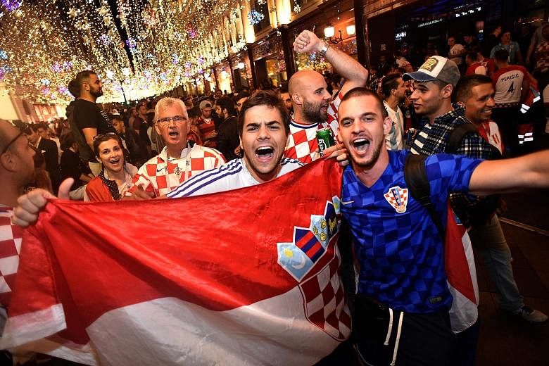 Croatian supporters celebrating early yesterday after their team's 2-1 win against England in the World Cup semi-final football match in Moscow on Wednesday night.