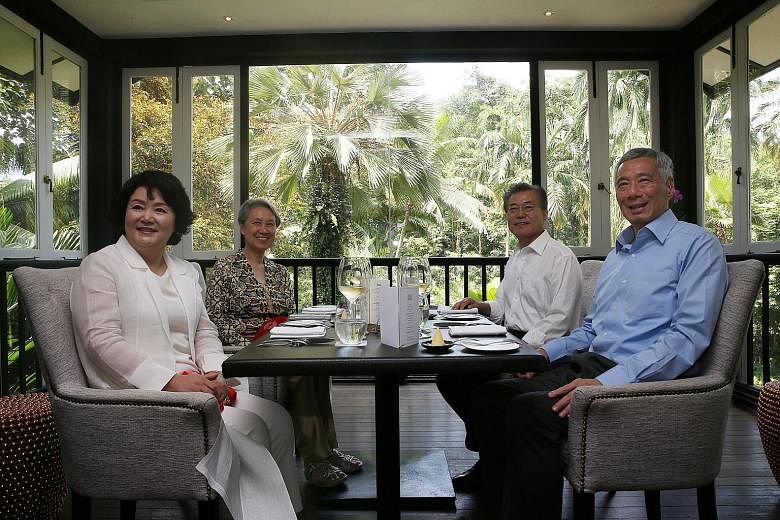 Prime Minister Lee Hsien Loong and Mrs Lee having lunch with South Korean President Moon Jae-in and his wife Kim Jung-sook at the Botanic Gardens yesterday. Mr Moon, who is here on a three-day state visit, said he and PM Lee agreed to expand bilatera