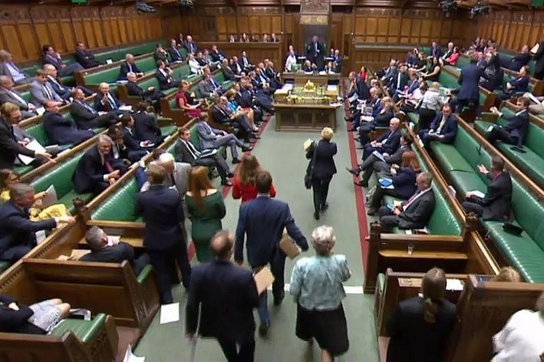 A video grab showing copies of the White Paper being brought into the House of Commons to be distributed to MPs yesterday. Mrs May published the 98-page White Paper setting out in detail the deep trading partnership Britain wants with the EU.