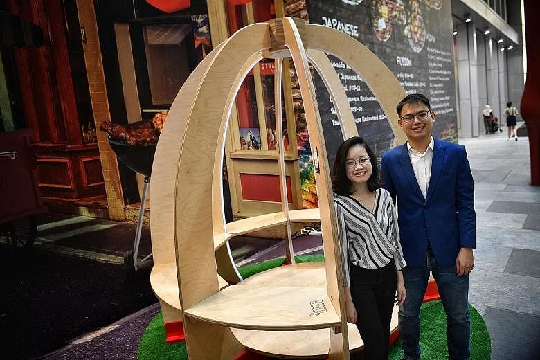 Ms Shirley Lee and Mr Galven Lee, co-founders of start-up StandCraft, with their winning design - the Peace and Power pavilion, which is equipped with wireless charging for phones and motion-sensor lighting.
