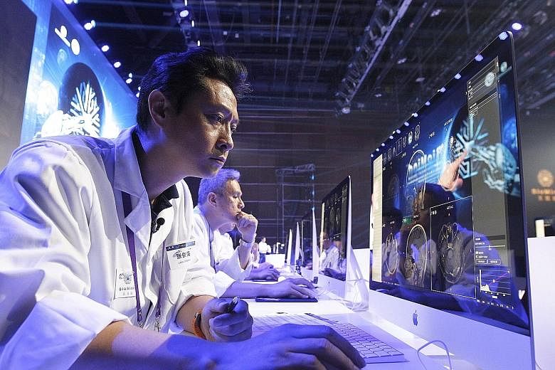 Doctors reading medical images on a screen during a diagnostic competition between an artificial intelligence machine and human experts at the China National Convention Centre in Beijing in June. China has picked up speed in innovation and is the onl
