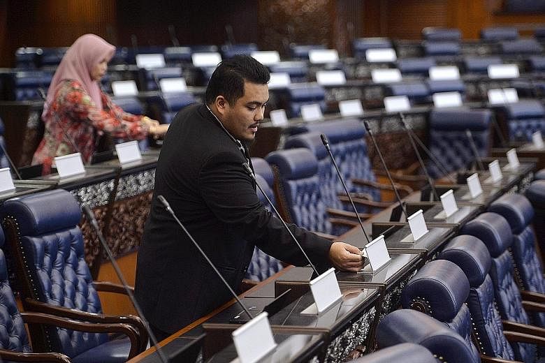 Staff preparing for Monday's Parliament session in Malaysia. Ninety of the 222 lawmakers who will take their oath are first-time MPs, the highest number since Parliament first convened in 1959. The 20-day sitting is expected to focus on rolling back 