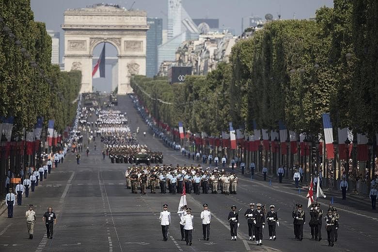 Troops on the Champs-Elysees during the Bastille Day parade in Paris yesterday. Prime Minister Lee Hsien Loong was a guest of honour at France's National Day Parade at the invitation of President Emmanuel Macron.
