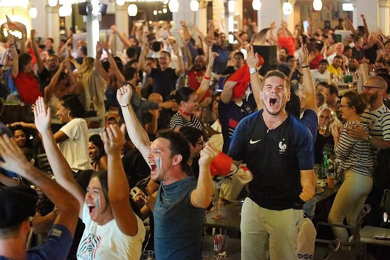 Guests at The Straits Times' viewing party cheering at 1-Altitude bar in Raffles Place, where 60 lucky subscribers and their plus ones joined ST staff and partners to catch the final. Croatia fans watch with their hearts sinking in Boat Quay. Ship ca