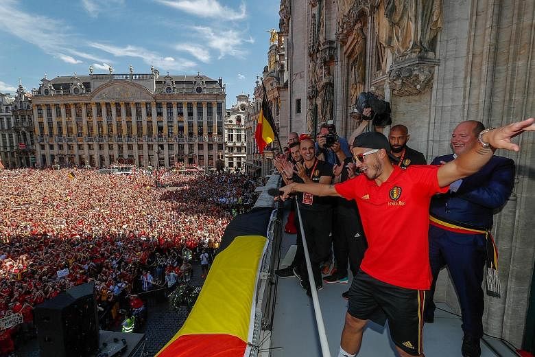 Belgium captain Eden Hazard strutting on the balcony of the Grand Place Town Hall in Brussels, to the delight of a jubilant crowd welcoming the team after they finished third in Russia.