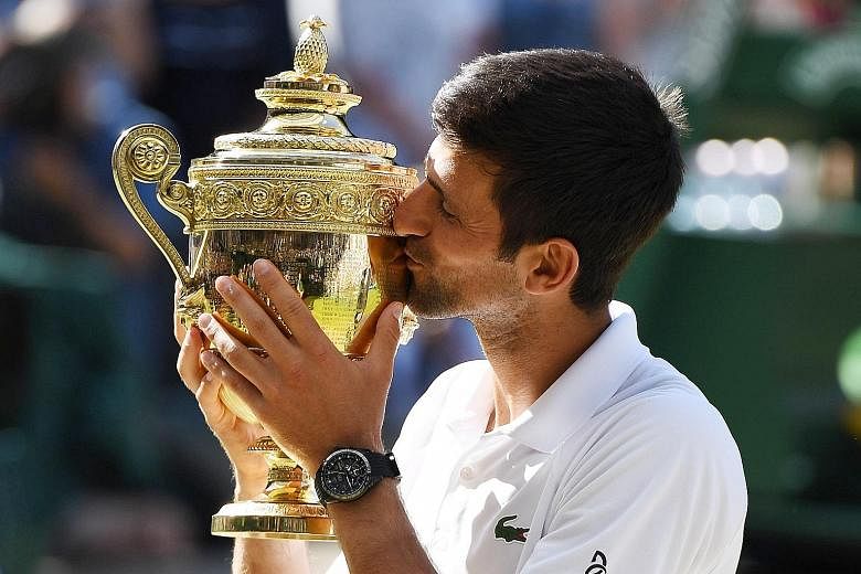 Novak Djokovic with the Wimbledon trophy after his 6-2, 6-2, 7-6 (7-3) win against Kevin Anderson yesterday. The former world No. 1 will move back into the top 10 after his victory.