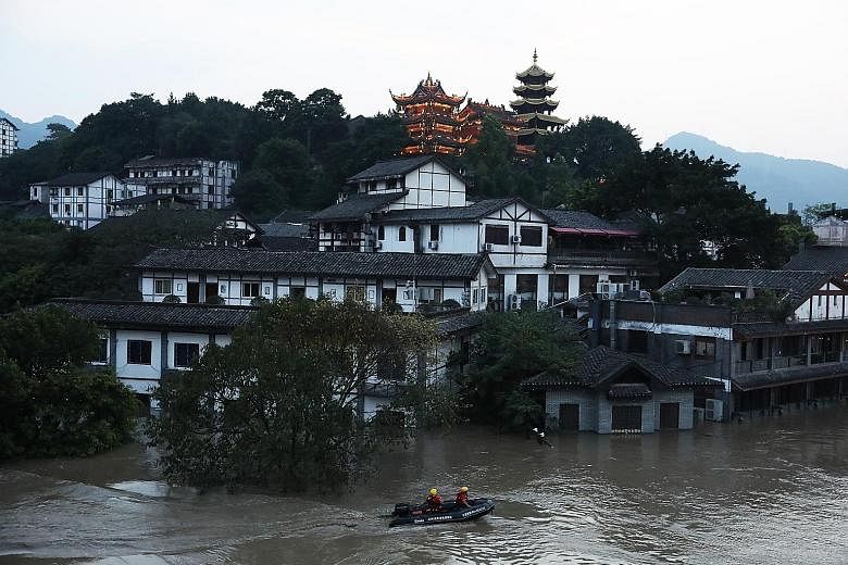 Anti-flood checks being carried out last Friday in the Jialing River, which flows through Chongqing city. At the Shuangliu International Airport in Chengdu, 52 inbound flights had to be diverted to other airports and more than 70 flights cancelled.