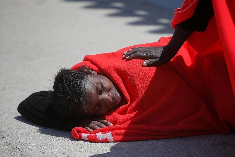 A migrant at the port of Tarifa in southern Spain last Saturday, after she was rescued from a toy dinghy in the Strait of Gibraltar. Germany said yesterday that it would take in 50 migrants, matching similar pledges by France and Malta. Italy has sin