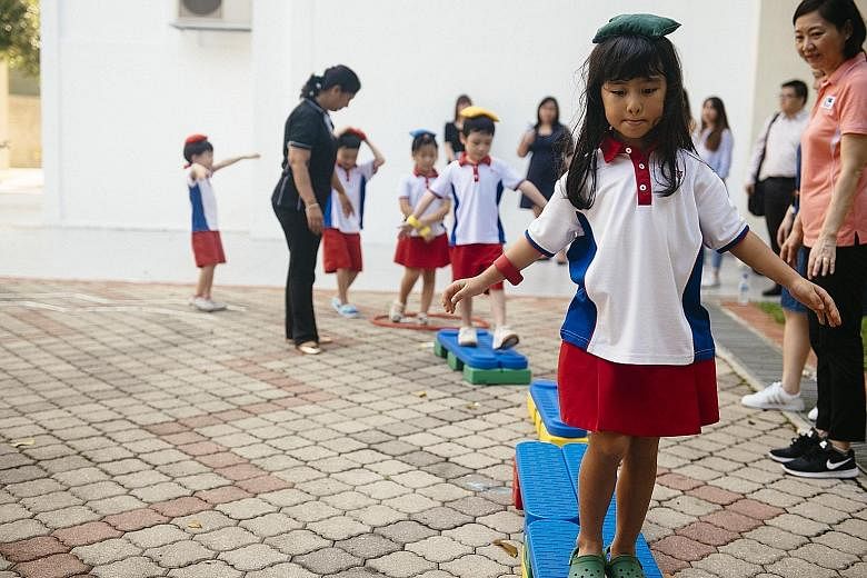 Pupils at a motor skill development lesson at the PCF Sparkletots Preschool in Ang Mo Kio. The exercise counts towards the criteria for accreditation as a "healthy pre-school", along with healthier meals and other requirements.