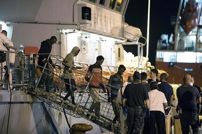 Migrants arriving at the Sicilian port of Pozzallo. The Italian ship Monte Sperone and British naval vessel Protector had picked up 450 asylum seekers from an overcrowded boat that left Libya last Friday.