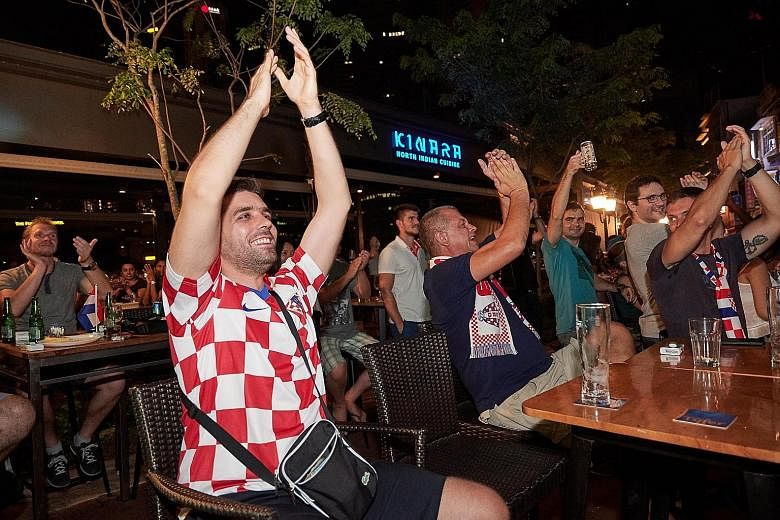 Croatia fans watching the World Cup final at a bar in Boat Quay. This year, 38 of the 64 matches during the month-long tournament were shown before midnight.