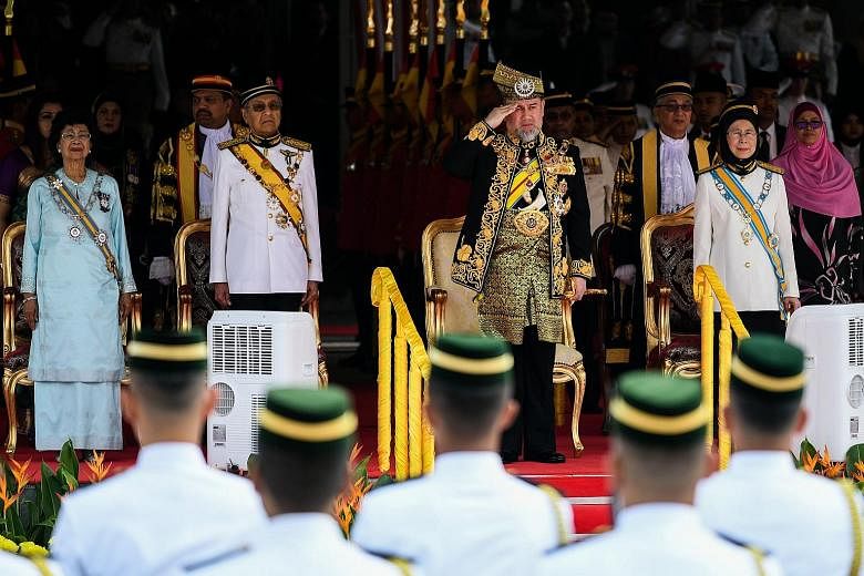 Above: Malaysia's King, Sultan Muhammad V, taking the salute at the opening of Malaysia's new Parliament in Kuala Lumpur, flanked by Prime Minister Mahathir Mohamad and Deputy Prime Minister Wan Azizah Wan Ismail. Beside Tun Dr Mahathir is his wife S