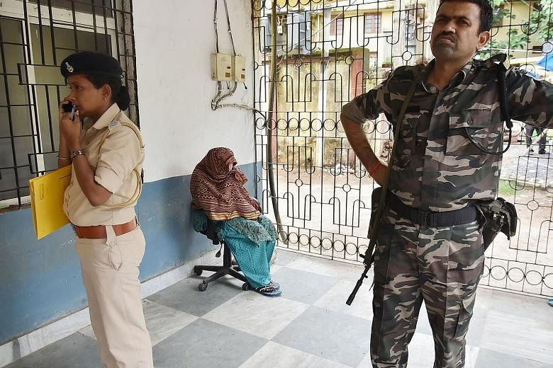 A nun from the Mother Teresa's Missionaries of Charity waiting before a court hearing on child trafficking charges in Ranchi, India, this month. The nun and a worker from one of the charity's homes were arrested for allegedly selling babies born to u