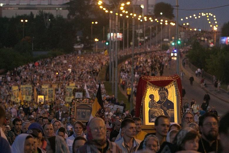 Russian Orthodox believers taking part in a night-time procession outside Yekaterinburg yesterday to mark 100 years since the Bolsheviks shot dead czar Nicholas II and his family after he abdicated.