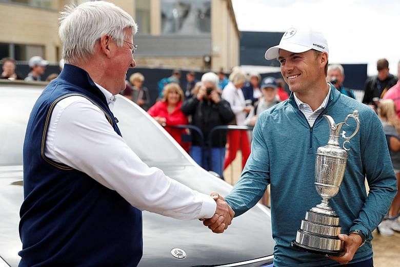 Defending champion Jordan Spieth shakes hands with R&A chief executive Martin Slumbers as he hands back the Claret Jug ahead of the 147th Open Championship in Carnoustie.
