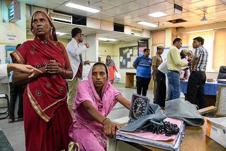 A woman in a New Delhi hospital waiting to be treated for heat stroke. Among the 100 most populous cities in the world where summer highs are expected to hit at least 35 deg C by 2050, 24 are in India.