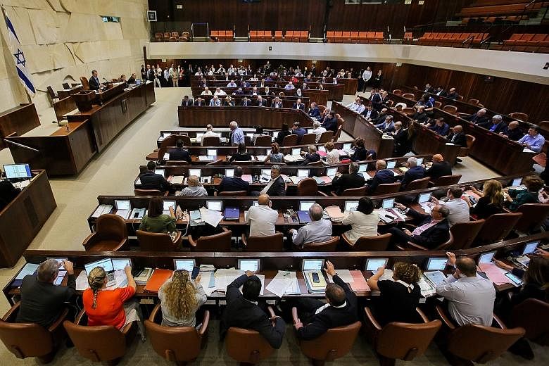 Israeli MPs at a Knesset session ahead of the vote on the new law.