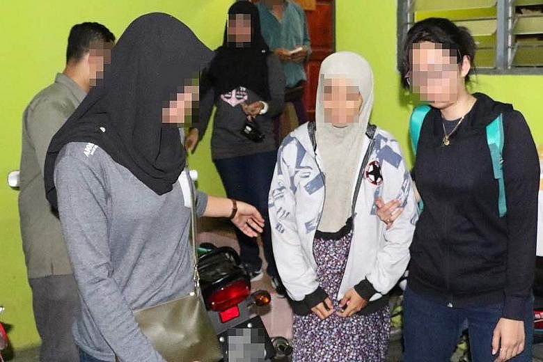 Malaysian police taking the suspected militants into custody. The arrests took place during a special operation in Johor, Terengganu, Selangor and Perak. One suspect had threatened online to kill Sultan Muhammad V, Malaysian Premier Mahathir Mohamad 