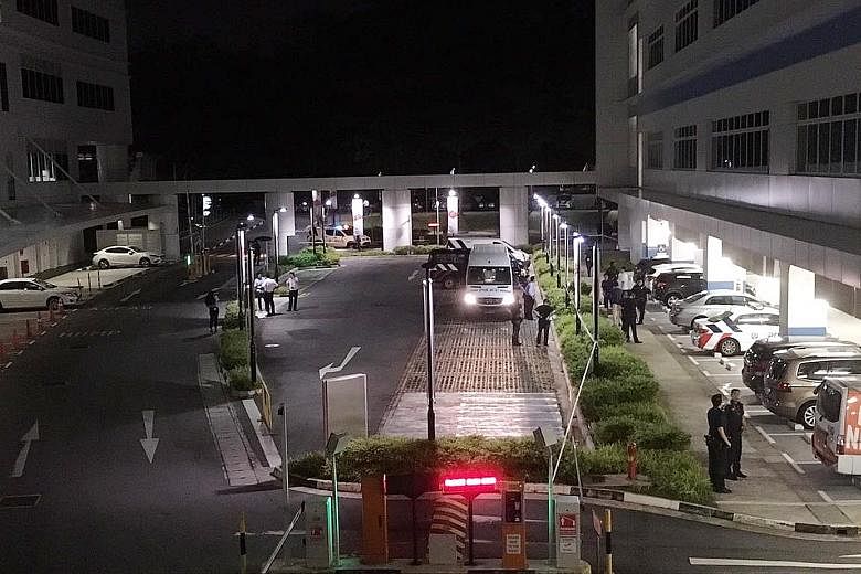 Police officers at the entrance to the sheltered carpark of ITE College Central in Ang Mo Kio, where a woman was believed to have been stabbed to death last night.
