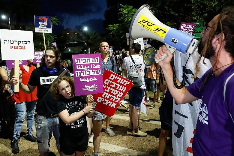 Protesters rallying against the Bill in Tel Aviv last Saturday. The Bill was passed yesterday with a slim majority of 62 to 55 votes, despite an intervention by President Reuven Rivlin a week ago. It was but one of dozens of laws pushed through in ma