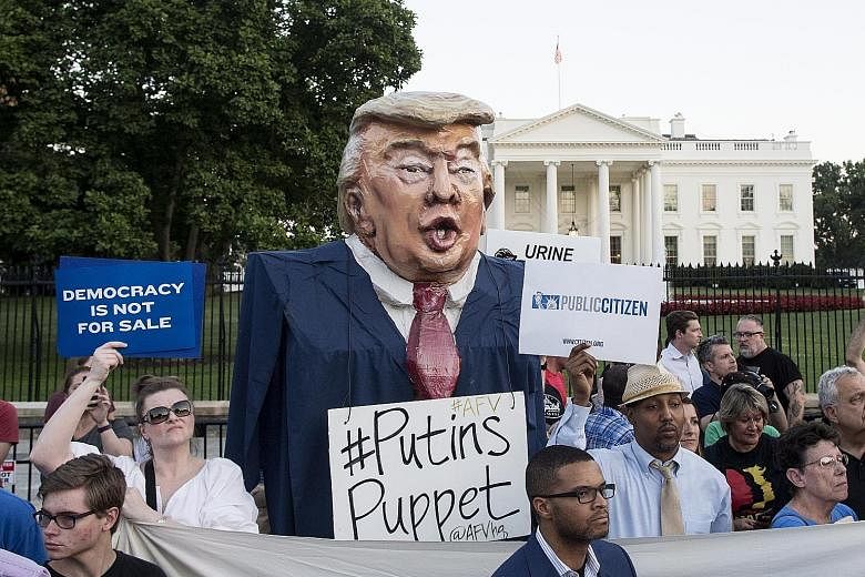 A puppet in the image of US President Donald Trump, labelled by critics as "Putin's Puppet", put up by protesters outside the White House on Wednesday. On his conflicting remarks, the White House said Mr Trump was misunderstood.