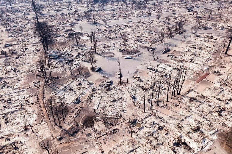 Fire damage seen from the air in Santa Rosa, California, last October. Anyone who pays much attention to climate change knows the outlook is grim, says the writer.