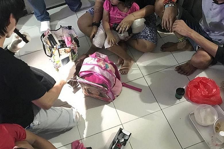 A four-year-old girl sitting on the lap of her mother who was busy getting high - that was the scene when CNB officers raided a one-room flat in Chin Swee Road last month.