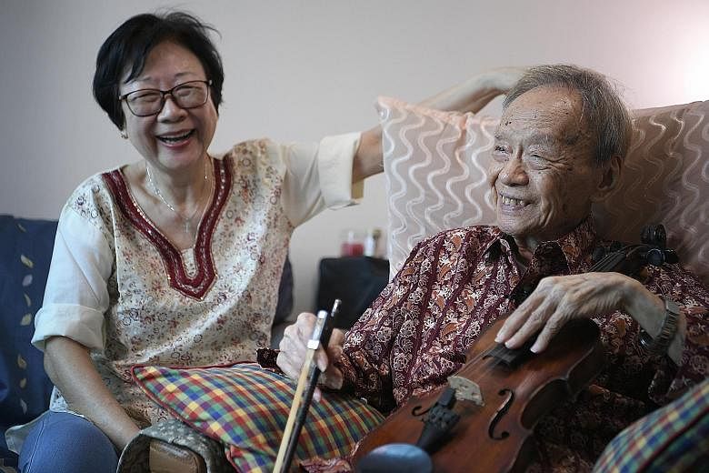 Mr Julai Tan at home with his wife, Madam Ng Siew Lan. Madam Ng, who jokes that her husband loves his violin more than her, is looking forward to his performance. Mr Tan will be performing a Bach piece, Air On The G String, and will be accompanied on
