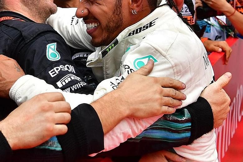 Lewis Hamilton celebrating with his Mercedes team after winning the German GP yesterday for his fourth victory this year.
