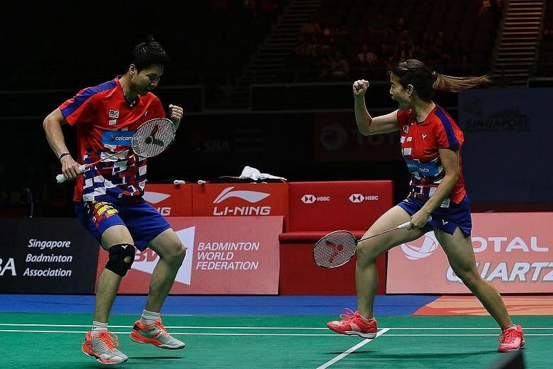 Malaysia's Goh Soon Huat and Shevon Jemie Lai celebrating after taming Olympic champions Liliyana Natsir (above) and Tontowi Ahmad of Indonesia in the Singapore Badminton Open mixed doubles final at the Singapore Indoor Stadium yesterday.