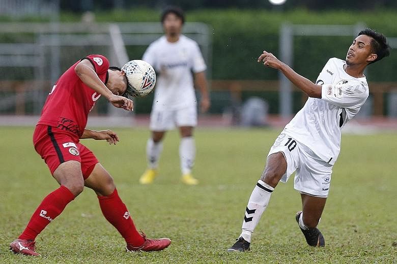 Albirex Niigata's Singapore player Adam Swandi (right), who has improved a lot this year, is stopped by a Balestier player yesterday.