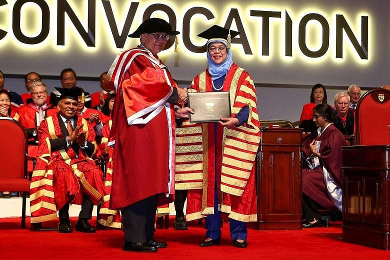 Dr Tony Tan Keng Yam receiving the honorary degree from President Halimah Yacob at Nanyang Technological University yesterday. Former head of civil service Peter Ho was awarded an honorary Doctor of Science. Lee Foundation chairman Lee Seng Tee recei