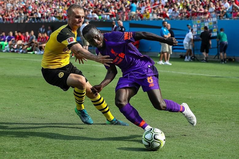 Liverpool midfielder Naby Keita evading Borussia Dortmund's Amos Pieper during the 3-1 loss to the German side in the International Champions Cup match at Charlotte, North Carolina, on Sunday. Manager Jurgen Klopp is hoping that his four signings, wh