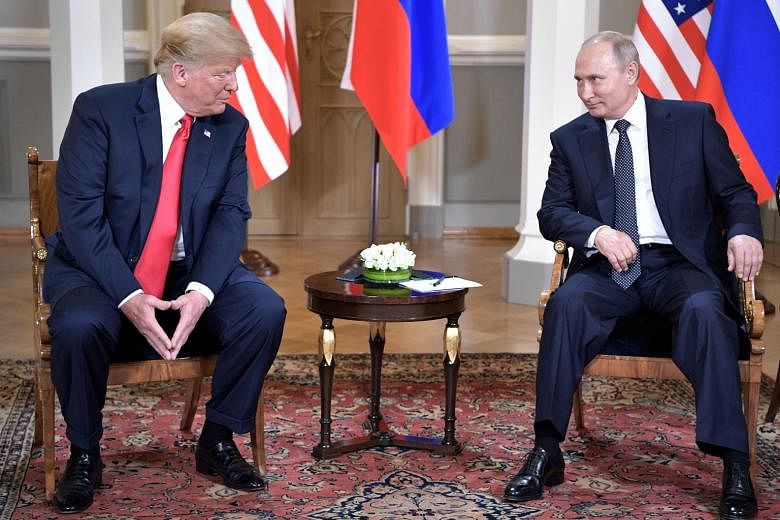 US President Donald Trump and Russian President Vladimir Putin at their summit in Helsinki, Finland, on July 16. The writer says that while the US President was seen by the Washington policy establishment to be disgracing himself on an international 