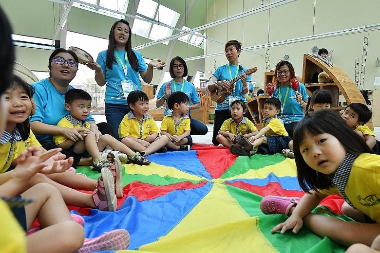 Teachers and children during a sing-along session at the Atelier Loft of the Skool4Kidz's campus yesterday. Minister for Social and Family Development Desmond Lee was there to officiate the opening of Skool4Kidz's large childcare centre at Sengkang R