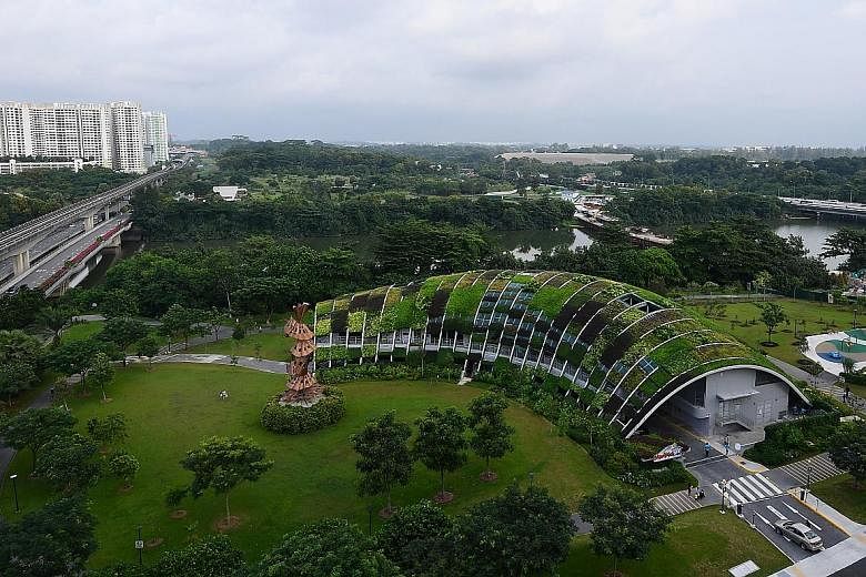 Above: Alyssa Ng Si Qi (front, left) and Li Run Tong, both six, at the KidzPatch garden adjacent to the Skool4Kidz campus. Top: Overview of the Skool4Kidz campus beside the Sengkang River. It is one of the nine large childcare centres already operati