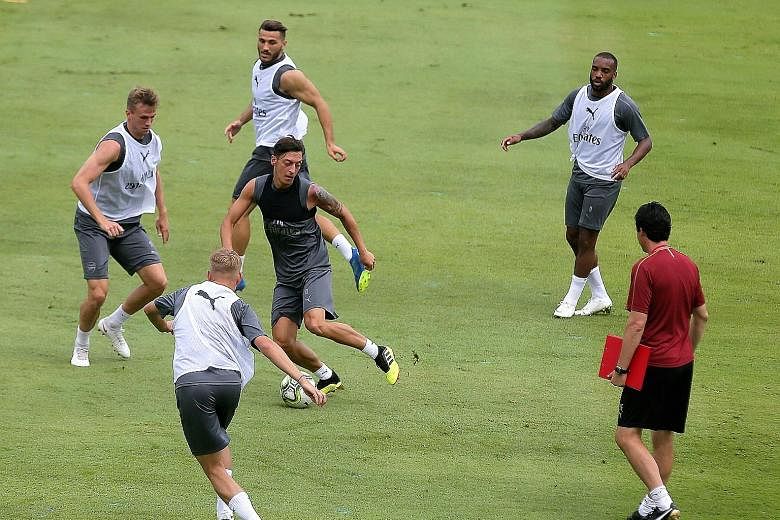 Wherever he goes, Mesut Ozil, on the ball, is usually the centre of attention. He and the Arsenal team trained yesterday at the Singapore American School ahead of their International Champions Cup match tonight against Atletico Madrid at the National