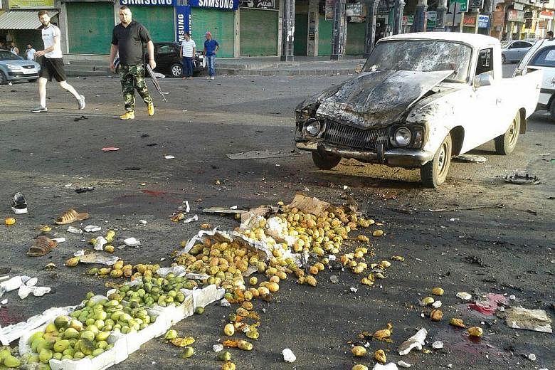 Syrian state television aired images of scattered vegetables and damaged cars on the streets of Sweida city, where four suicide bombers struck yesterday.