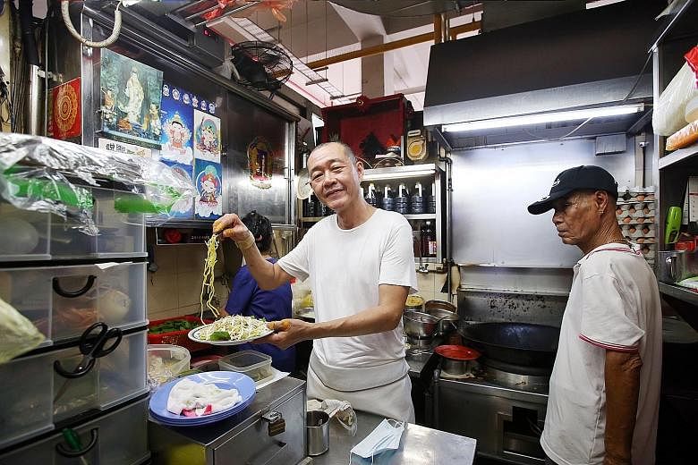 Mr Tan Lee Seng (left) is the owner of Lao Fu Zi Fried Kway Teow in Old Airport Road Food Centre that made it to this year's Michelin Singapore Bib Gourmand list.