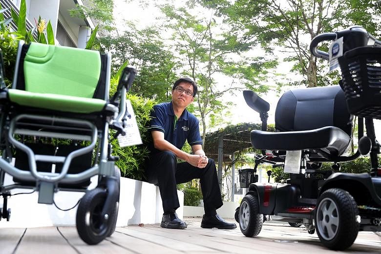 Mr Warren Chew of Falcon Mobility with some of the motorised wheelchairs and mobility scooters typically available for disabled and elderly users here.